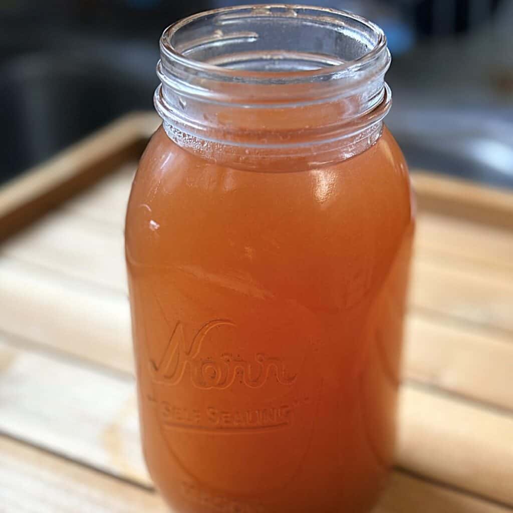 a quart jar full of apple cider