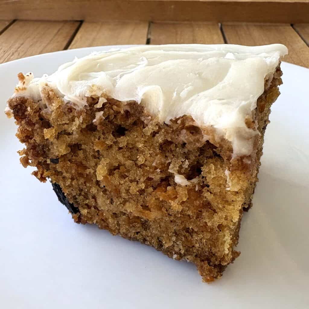 carrot walnut cake sitting on a white plate